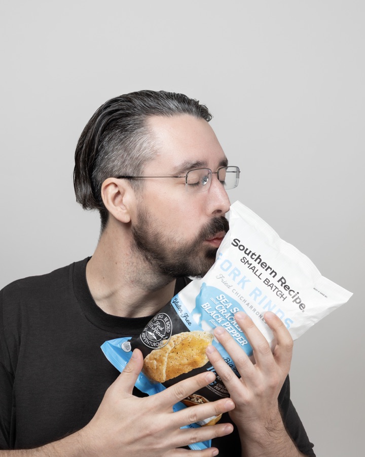 Everett Jamal Hall holding a bag of pork rinds.